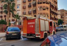 Los bomberos de Alicante luchan por rescatar a una anciana del interior de su vivienda en el Barrio del Altozano