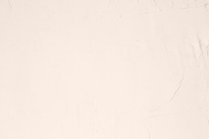 A white sheet with a black cat sitting on top of it