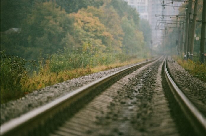 a train track with trees in the background