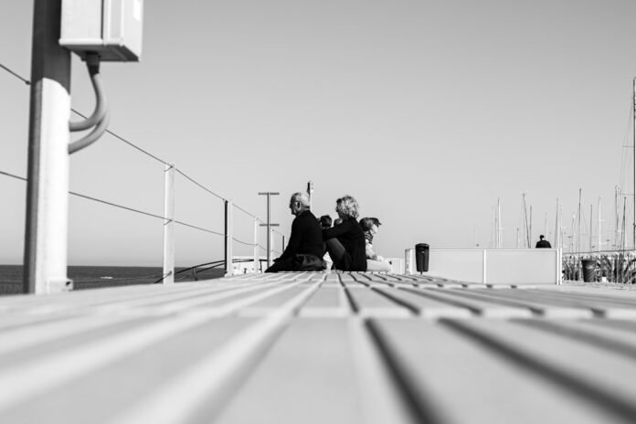 image_1771279231780 man and woman sitting on concrete bench