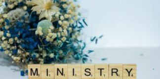 La tensión entre el Ministerio de Sanidad y los profesionales médicos alcanza un punto crítico a scrabble block spelling the word mn, in front of a bouquet of