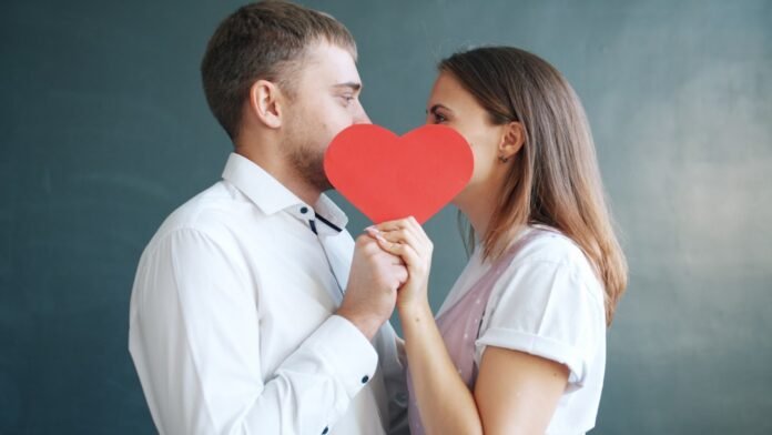 image_1771448425674 Couple holding red heart obscuring faces