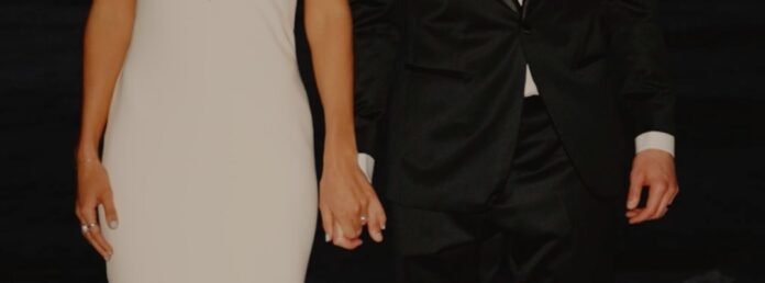 a woman in a white dress and a man in a black suit