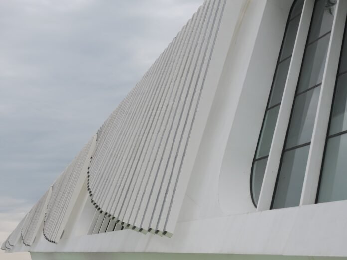 image_1771635648187 a large white building with a clock on it's side