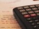 Estrategias para reducir la factura eléctrica ante el alza de precios energéticos a calculator sitting on top of a piece of paper