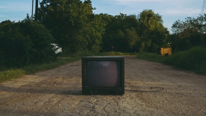 black crt tv on brown soil