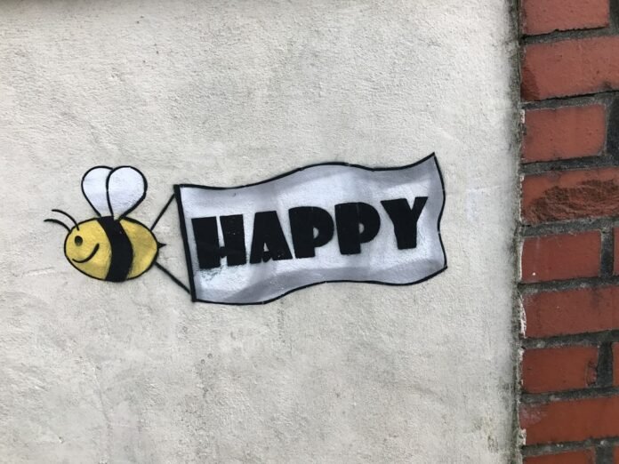 image_1772784034160 a sign that says happy with a bee on it