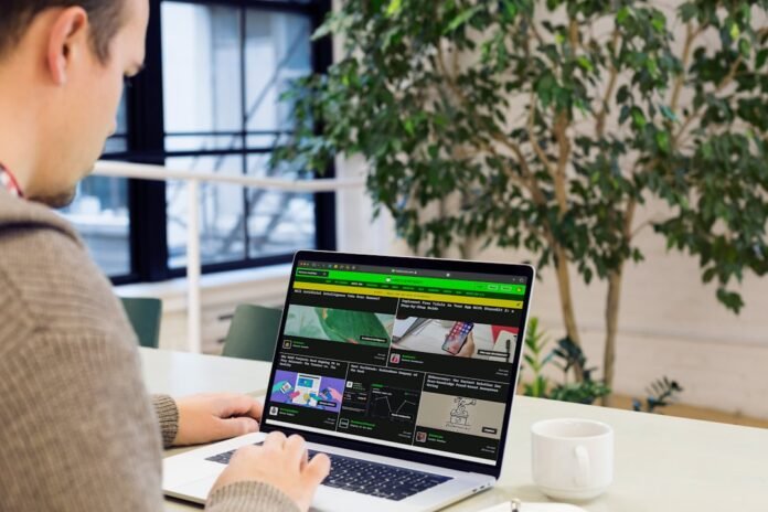 image_1772967626516 A man sitting at a desk using a laptop computer