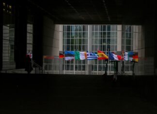 La Diplomacia Bilingüe de Marco Rubio Marca un Nuevo Capítulo en las Relaciones Hemisféricas a group of flags hanging from the side of a building