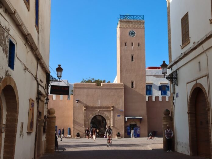 A moroccan landmark with arches and a clock tower.