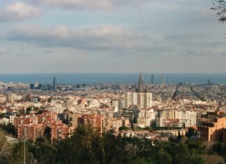 El Desafío del Barcelona: Mantener el Liderazgo Entre Múltiples Frentes Panoramic cityscape with buildings and the ocean in background
