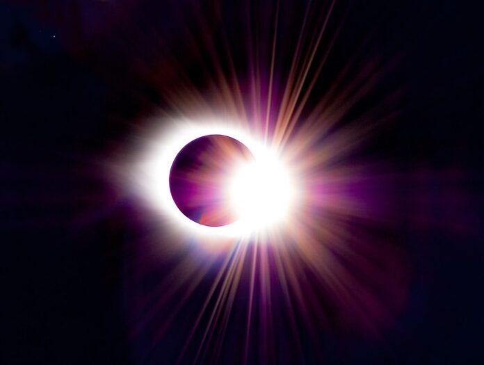 a solar eclipse is seen in the dark sky