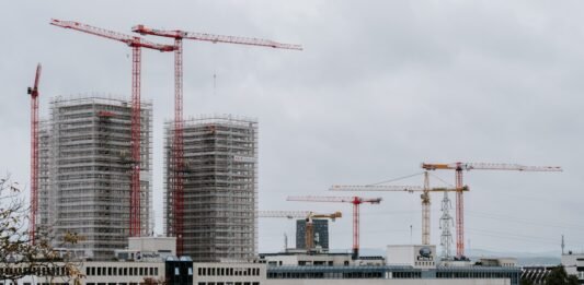 a group of cranes next to a building