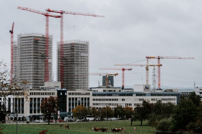 image_1774728026006 a group of cranes next to a building