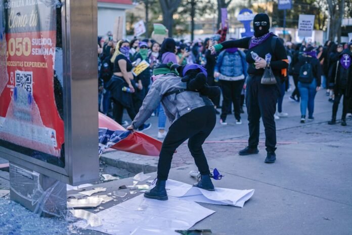 image_1774843227801 a group of people standing on a street next to a building