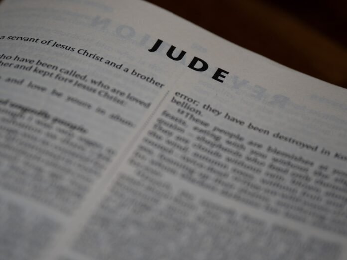 The book of jude is shown open.