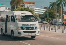 Sector del Transporte y Gobierno Alcanzan Acuerdo Provisional tras Intensas Negociaciones A white passenger van driving on a street.