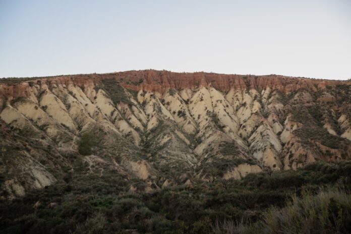 image_1775037626469 A view of a mountain with a sky in the background