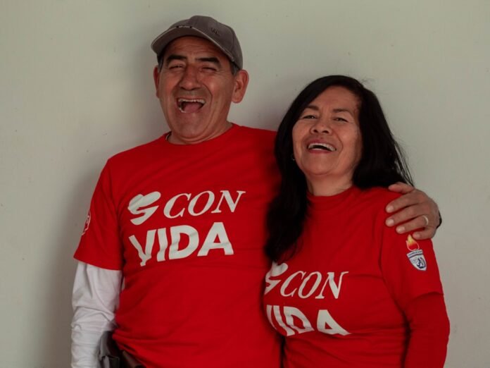 A man and a woman wearing red shirts