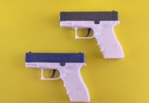 Pistolas de Pintura 2026: Tecnología y Eficiencia Transforman el Sector de la Construcción Two white and blue toy guns on a yellow background