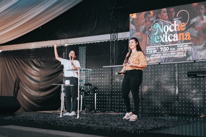 a woman standing next to a man on a stage