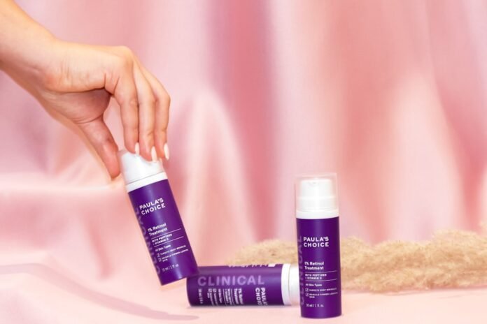 person holding white and blue plastic tube bottle