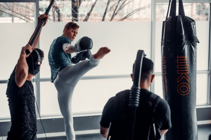a group of people in a gym with punching gloves