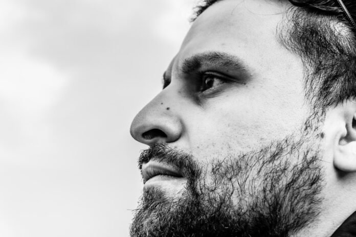 Close-up profile of a bearded man looking away