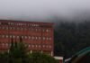 La polémica por la información sobre regularización migratoria a internos genera debate político en España A red brick building with a forest in the background