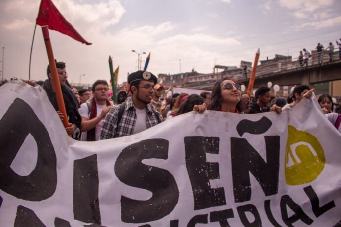 group of people holding Disen text tarpaulin