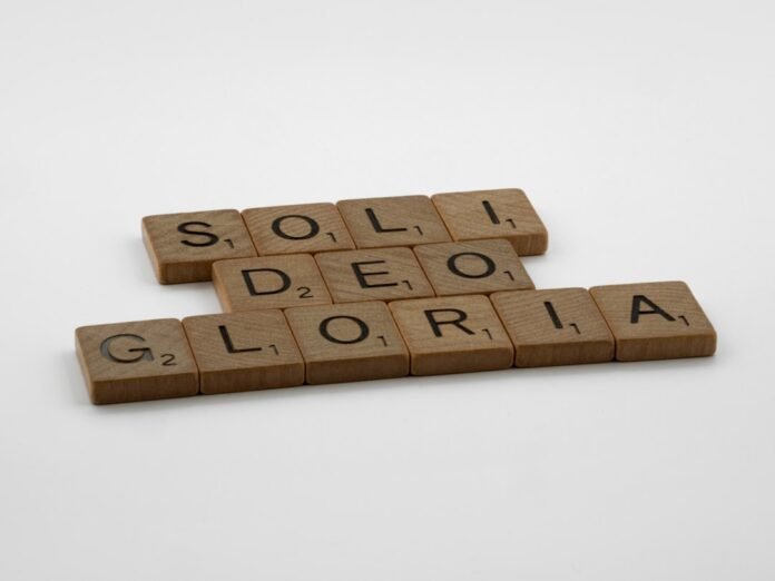 scrabble tiles spelling the word solei deo gloria