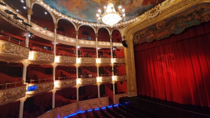 a room with a stage and a curtain