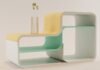 La revolución del mobiliario modular: cómo transformar espacios con sistemas flexibles de almacenaje a white and yellow shelf with two vases on top of it