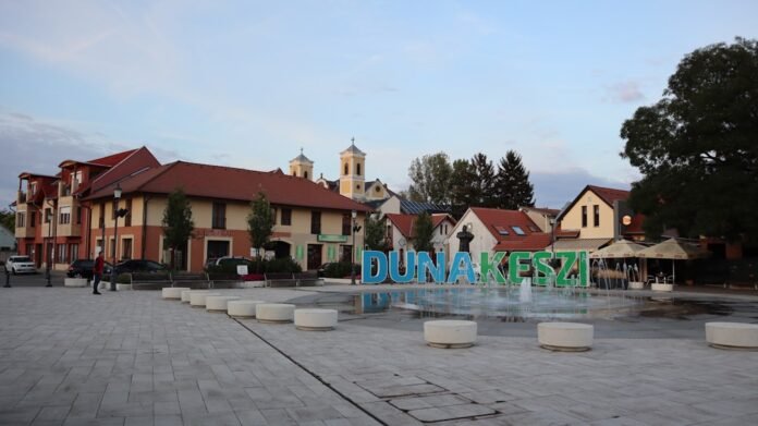 a town square with a fountain in the middle of it