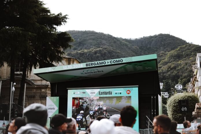 A group of people standing in front of a large screen