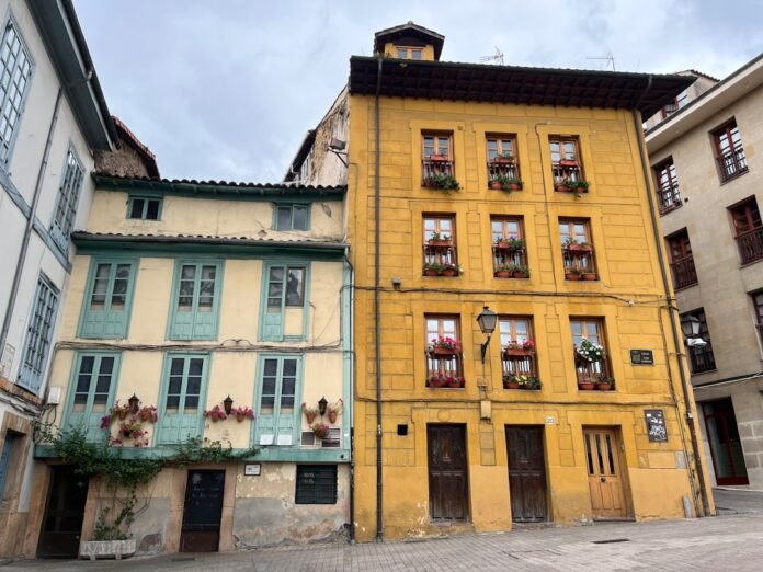 Colorful old buildings with flowers on balconies.
