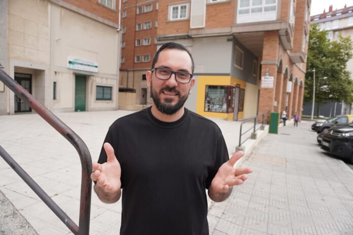 Man with glasses and beard gesturing outdoors