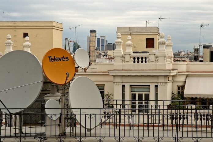 white and orange street sign near white concrete building during daytime