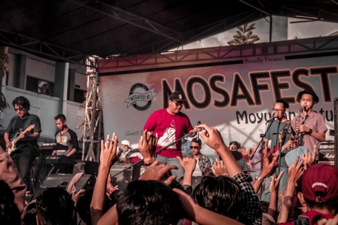 a group of people standing on top of a stage