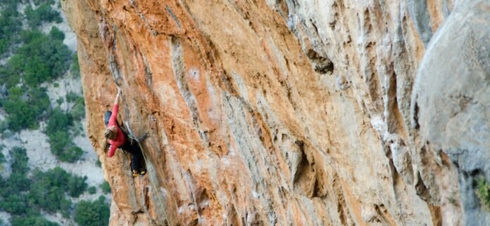 person climbing mountain during day