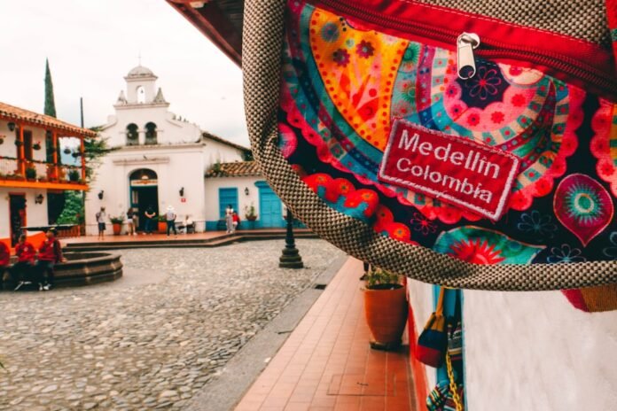 image_1780405231169 a colorful bag hanging from the side of a building