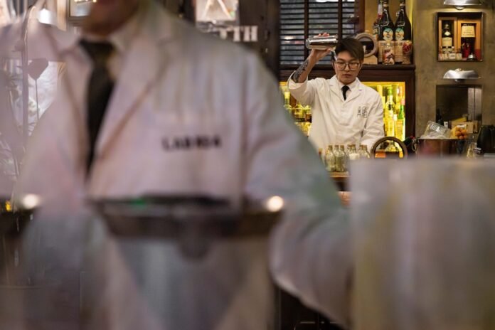 image_1780513227002 A man in a white lab coat holding a tray of food