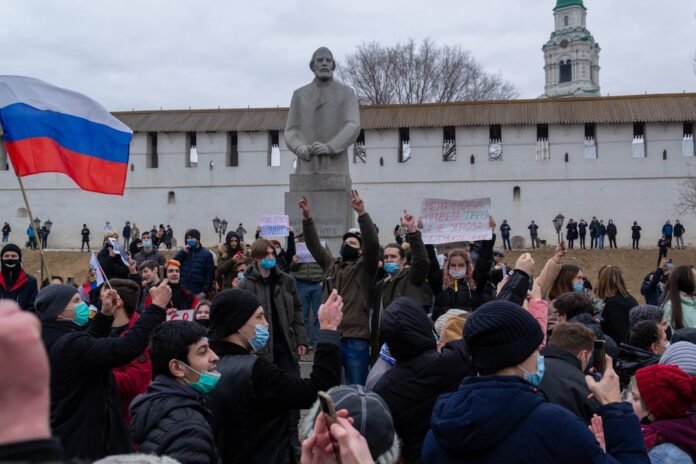 image_1780761628089 a crowd of people in front of a statue