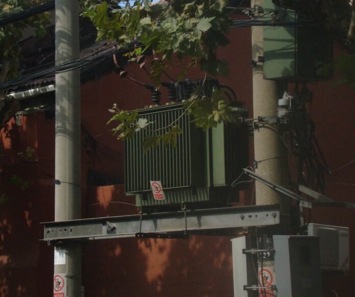 image_1780902028095 a street sign on a pole in front of a building
