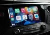 Apple CarPlay Transforma la Experiencia de Conducción en España: Innovaciones que Marcan el Rumbo a car dashboard with various app icons on it
