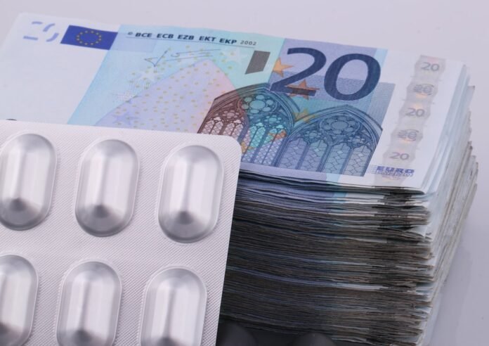 a bunch of pills sitting on top of a pile of money