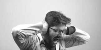 El síndrome del móvil hiperconectado: Cómo recuperar el control de tu tiempo y atención man in gray dress shirt wearing black framed eyeglasses