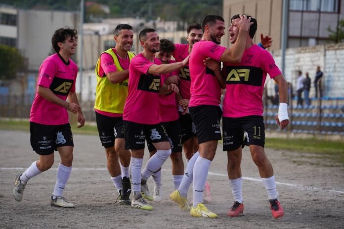 Soccer team celebrates a goal on the field.
