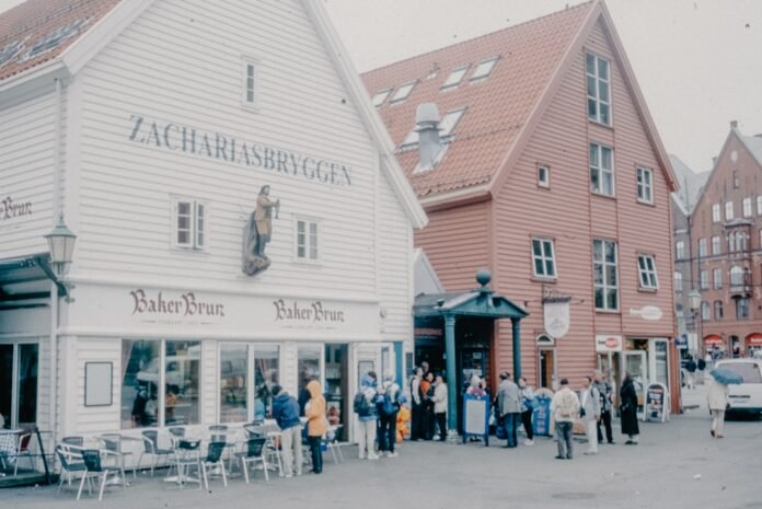 A group of people standing outside of a white building