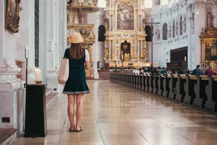 Woman stands and looks at the church's interior.